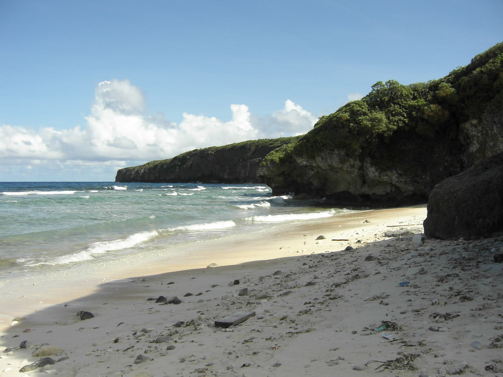 Turquoise water and limestone coast at Masalok Beach, Tinian